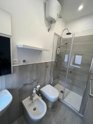 a bathroom with a shower and a toilet and a sink at LB Home in Termini Imerese