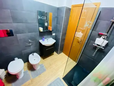 a bathroom with a toilet and a sink and a shower at Casa Niní in Campofelice di Roccella