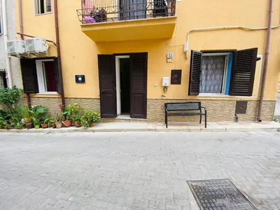 a bench sitting in front of a building at Casa Niní in Campofelice di Roccella