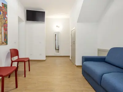 a living room with a blue couch and chairs at Apartment Sole by Interhome in Balestrate