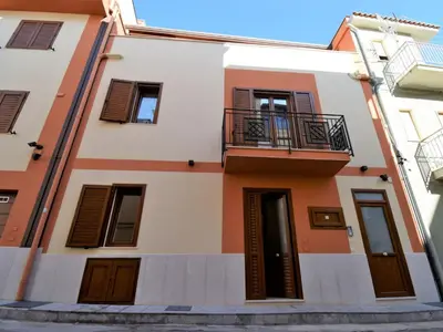 a building with a balcony on a street at Apartment Sole by Interhome in Balestrate