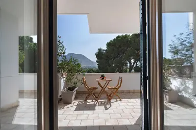 a view of a patio from a glass door at Hector's House by DomuSicily in Palermo