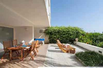 a patio with a table and chairs on a balcony at Hector's House by DomuSicily in Palermo