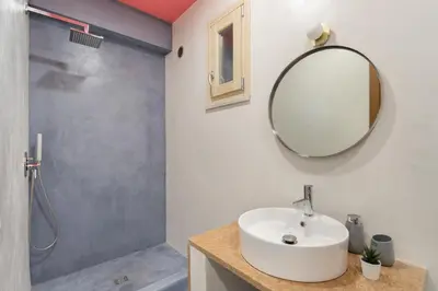 a bathroom with a sink and a shower and a mirror at Hector's House by DomuSicily in Palermo