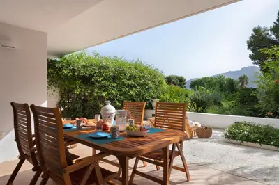 a wooden table and chairs on a patio at Hector's House by DomuSicily in Palermo