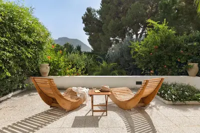 two chairs and a table on a patio at Hector's House by DomuSicily in Palermo