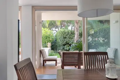 a dining room with a table and chairs and a patio at Hector's House by DomuSicily in Palermo