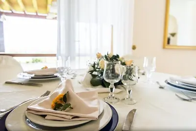 a dining room table with a plate of food on it at Allegroitalia Torre Artale Palermo in Trabia