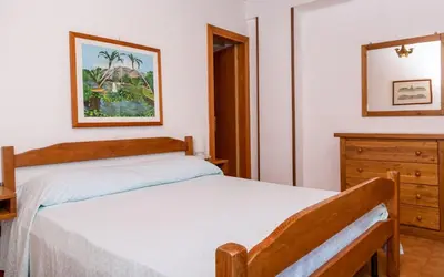 a bedroom with two beds and a dresser at Allegroitalia Torre Artale Palermo in Trabia