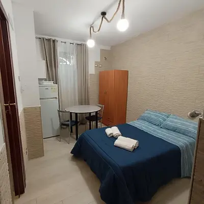 a bedroom with a blue bed with towels on it at Casa alla Stazione in Palermo