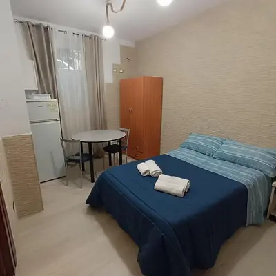 a bedroom with a blue bed with towels on it at Casa alla Stazione in Palermo