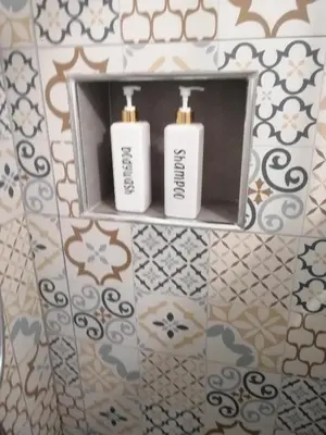 two white toothbrushes on a shelf in a bathroom at Casa alla Stazione in Palermo