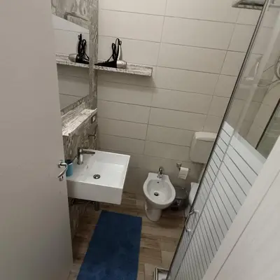 a bathroom with a sink and a toilet at Casa alla Stazione in Palermo