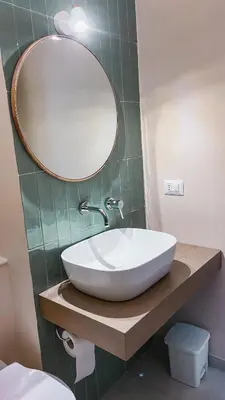 a bathroom with a white sink and a mirror at Casa di Giulietta in Palermo