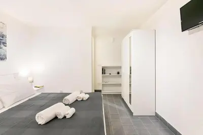 a white room with three white pillows on the floor at Casa Musicò in Palermo