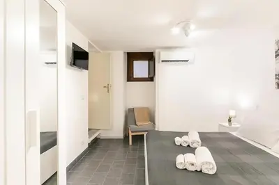 a room with a bathroom with white shoes on the floor at Casa Musicò in Palermo