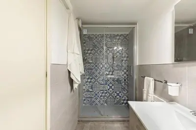 a bathroom with a shower with a tub and a sink at Casa Musicò in Palermo