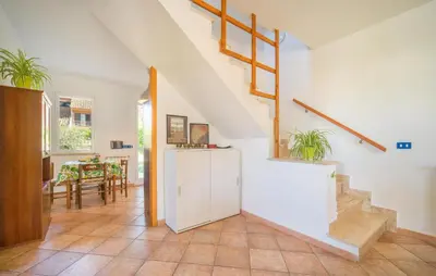 a living room with stairs and a dining room at Lovely Home In Piane Vecchie,Lascari in Lascari