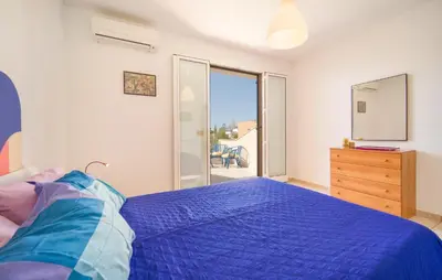 a bedroom with a bed and a dresser and a window at Lovely Home In Piane Vecchie,Lascari in Lascari