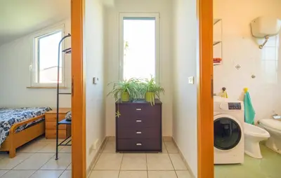 a bathroom with a sink and a washing machine at Lovely Home In Piane Vecchie,Lascari in Lascari