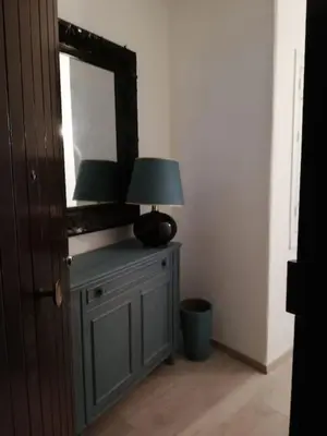 a lamp on a table in a room with a mirror at Cala Apartment Centre in Palermo