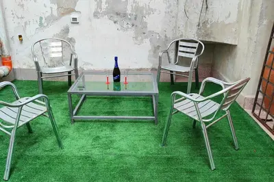 a table and two chairs with a bottle of wine at Cala Apartment Centre in Palermo
