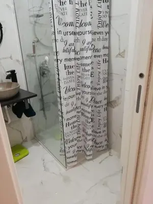 a shower curtain with writing on it in a bathroom at Cala Apartment Centre in Palermo