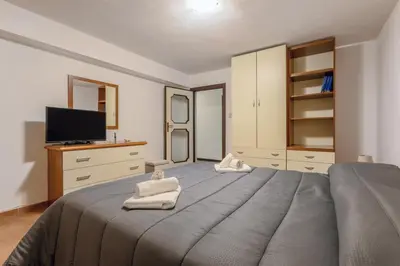a bedroom with a large bed with towels on it at Casa in Villa a Mondello-700m dal mare in Palermo
