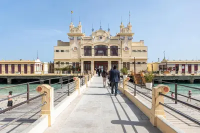 a building on a pier next to the water at Casa in Villa a Mondello-700m dal mare in Palermo