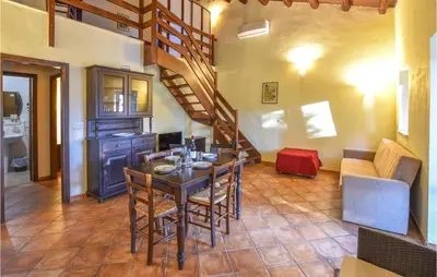 a dining room with a table and a staircase at Rosmarino in San Giuseppe Jato