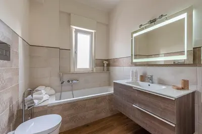 a bathroom with a sink and a tub and a toilet at Appartamento Libertà con Terrazza by Wonderful Italy in Palermo