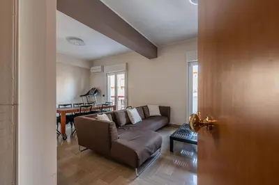 a living room with a couch and a table at Appartamento Libertà con Terrazza by Wonderful Italy in Palermo
