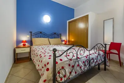 a bedroom with a bed and a desk and a chair at Principe Tancredi in Castellammare del Golfo