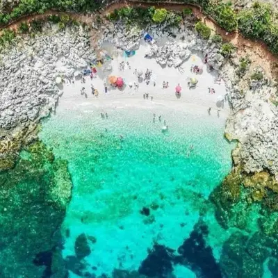an aerial view of a beach with people in the water at Principe Tancredi in Castellammare del Golfo