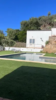 a swimming pool in front of a white building at Villa Laura in Cefalù