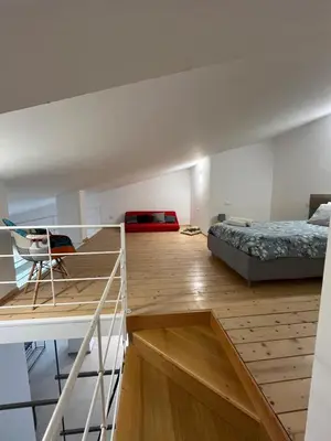 a loft bedroom with a bed and a desk and a bed at Villa Laura in Cefalù