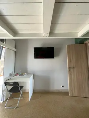 a room with a desk and a tv on the wall at S&S in Palermo