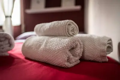 a pile of towels sitting on top of a bed at S&S in Palermo
