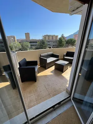 a balcony with couches and tables on a building at S&S in Palermo
