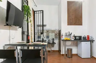 a dining room with a table and a television in a room at DaMé in Palermo
