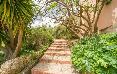 a garden path with trees and plants at Salvia in San Giuseppe Jato