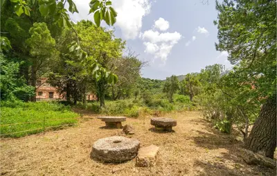 two stone benches sitting in the middle of a field at Salvia in San Giuseppe Jato
