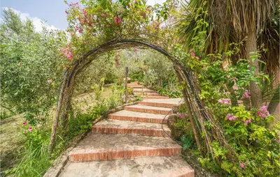 an archway with stairs in a garden with flowers at Salvia in San Giuseppe Jato