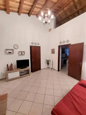 a large living room with a bed and a tv at CASA di ARTHUR in Palermo