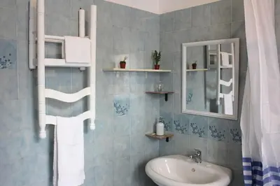 a bathroom with a sink and a mirror at Sicilia Nica - appartamento privato a Cinisi (PA) in Cinisi