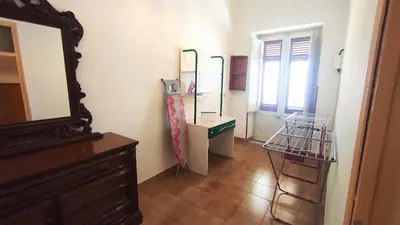a room with a mirror and a dresser and a dresser with a chair at Sicilia Nica - appartamento privato a Cinisi (PA) in Cinisi