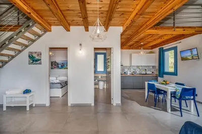 a kitchen and dining room with a table and chairs at Villa Holidays in Torre Bennistra in Scopello