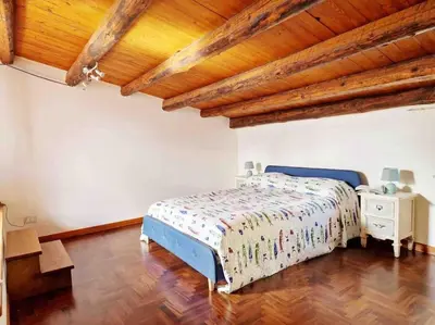 a bedroom with a bed and a wooden ceiling at Casa Al Plumbago in Termini Imerese
