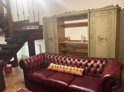 a brown leather couch sitting in a living room at Casa Al Plumbago in Termini Imerese