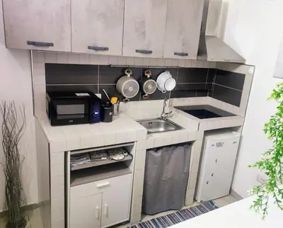 a small kitchen with a sink and a microwave at Montesanto House Palermo in Palermo